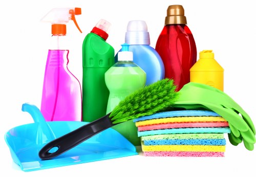 Carpet cleaning technician preparing equipment with safety measures in place